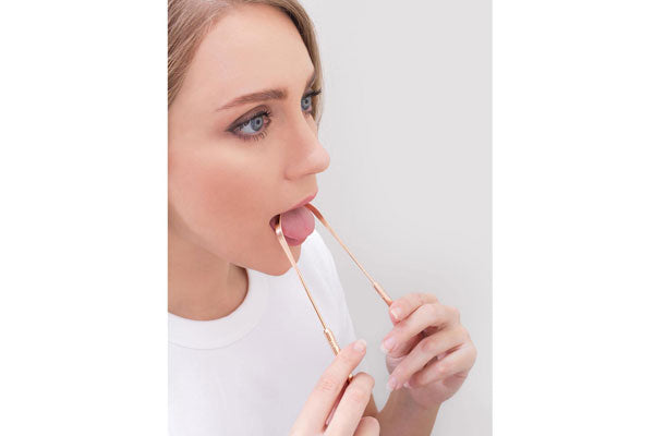 using a tongue cleaner